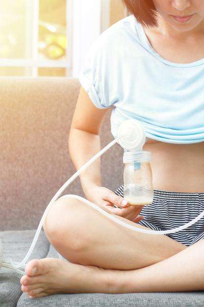 image of woman using breast pump