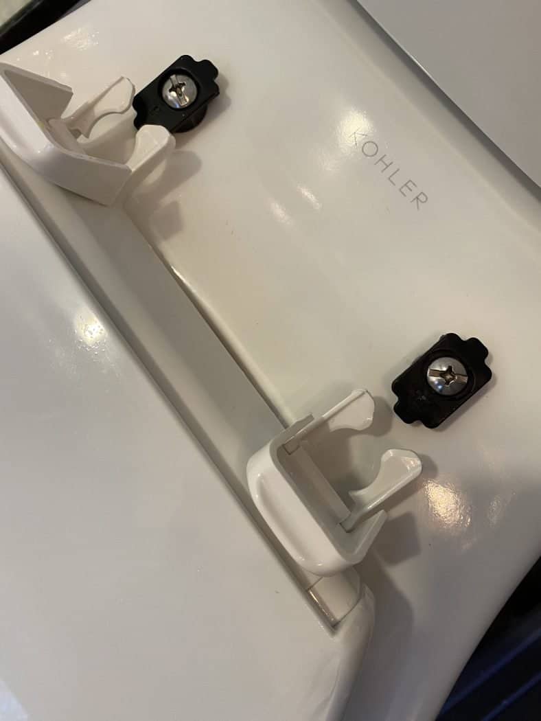 Toilet hinges that need to be cleaned to get rid of bacteria and urine.