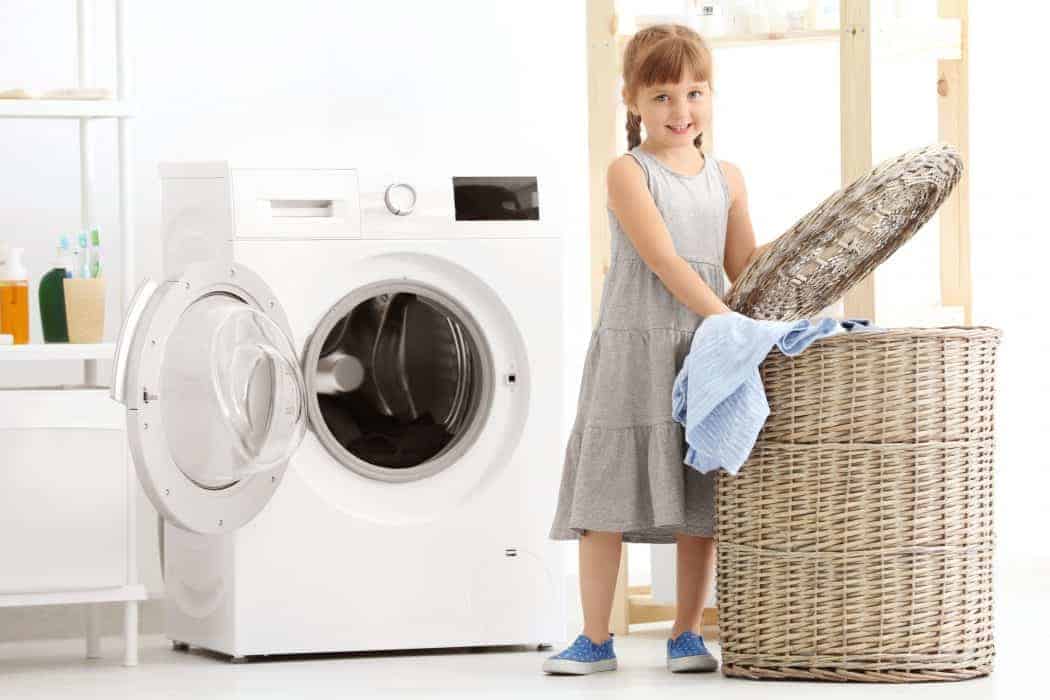 Little girl helping with laundry.