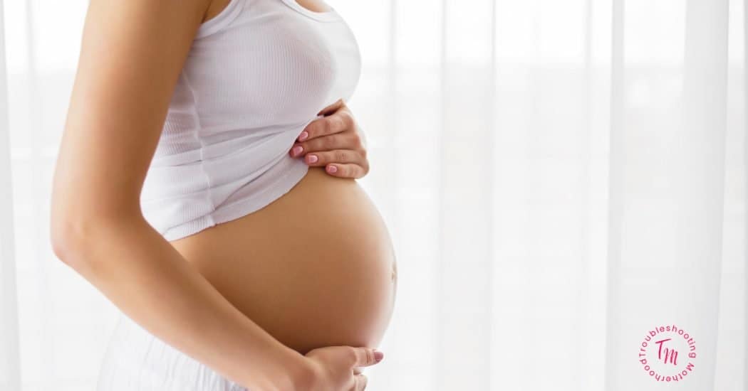 Best Pregnancy Safe lotions to use for stretch marks and dry skin while pregnant. Image of pregnant stomach.