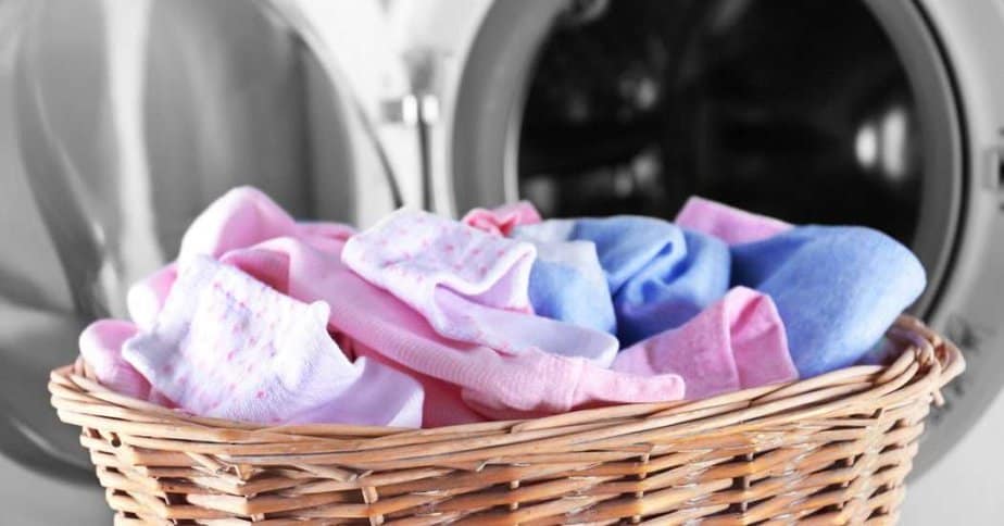 baby laundry in a basket. washing baby clothes in washing machine