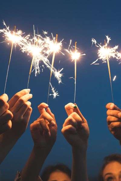 kids hands holding sparklers