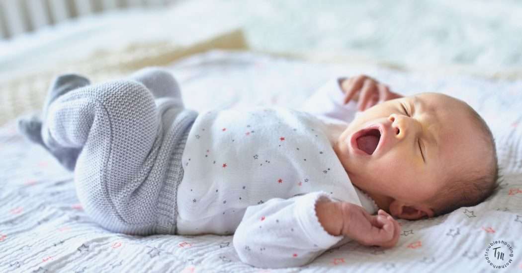 Gender Neutral Baby Names. Image of newborn baby yawning and stretching.