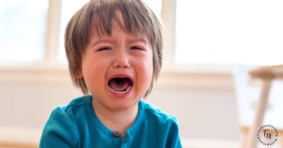 Toddler crying at bedtime during a bedtime routine for toddlers, showing common nighttime emotions in young children. Toddler cries at bedtime.