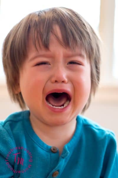 Toddler crying during bedtime routine, showing common nighttime emotions many parents experience with young children