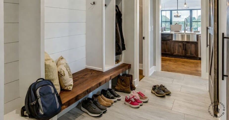 A family entryway with shoes and a backpack on the floor showing how a house gets messy so fast even when you clean